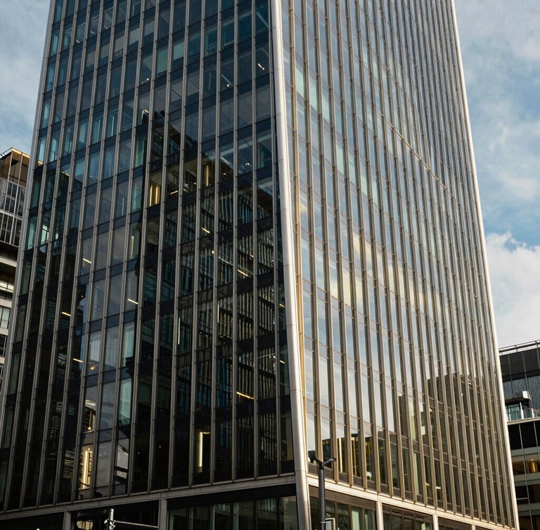 Sharp architectural crop of modern glass and steel skyscraper in London financial district, bright natural daylight, deep navy shadows, editorial style, 35mm lens