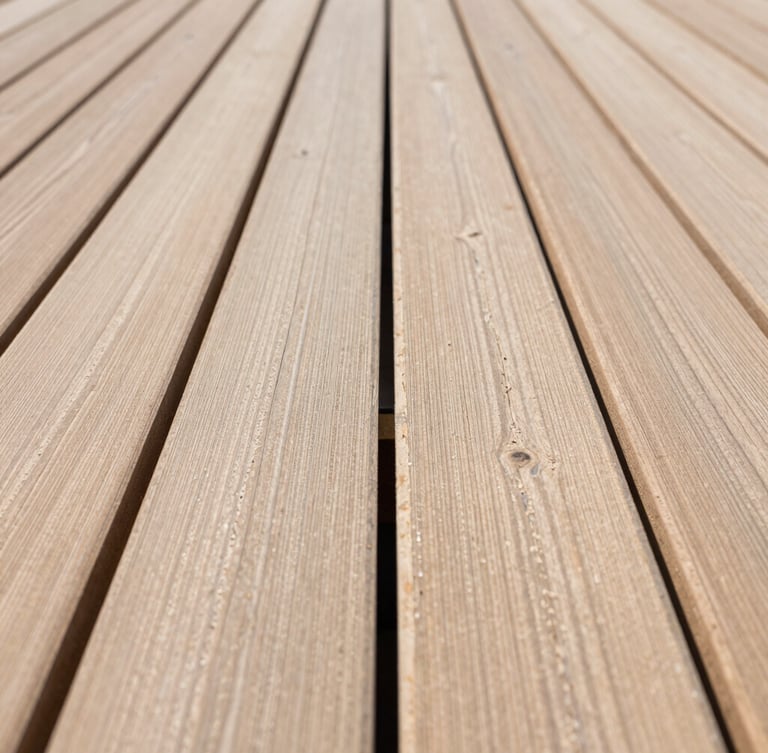 Sharp, straight-on architectural close-up of perfectly aligned timber decking joints, bright natural daylight, clean lines, professional carpentry craftsmanship.