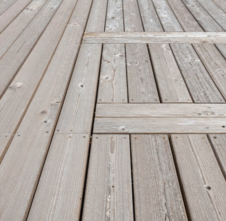 Straight-on architectural shot of perfectly aligned timber decking joints under bright natural daylight, highlighting millimeter-precise craftsmanship and clean structural lines.