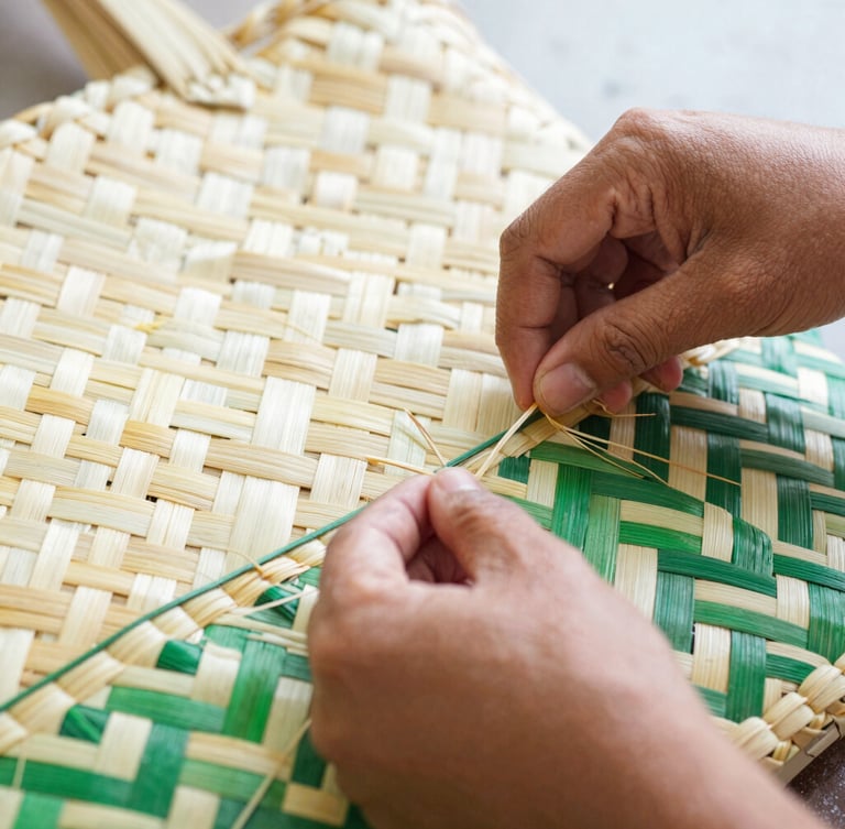 Close-up of Indonesian artisan's hands weaving natural fibers into a basket bag, focused on the intricate texture and motion, bright natural morning light, cheerful cream and green tones, detailed texture, 35mm