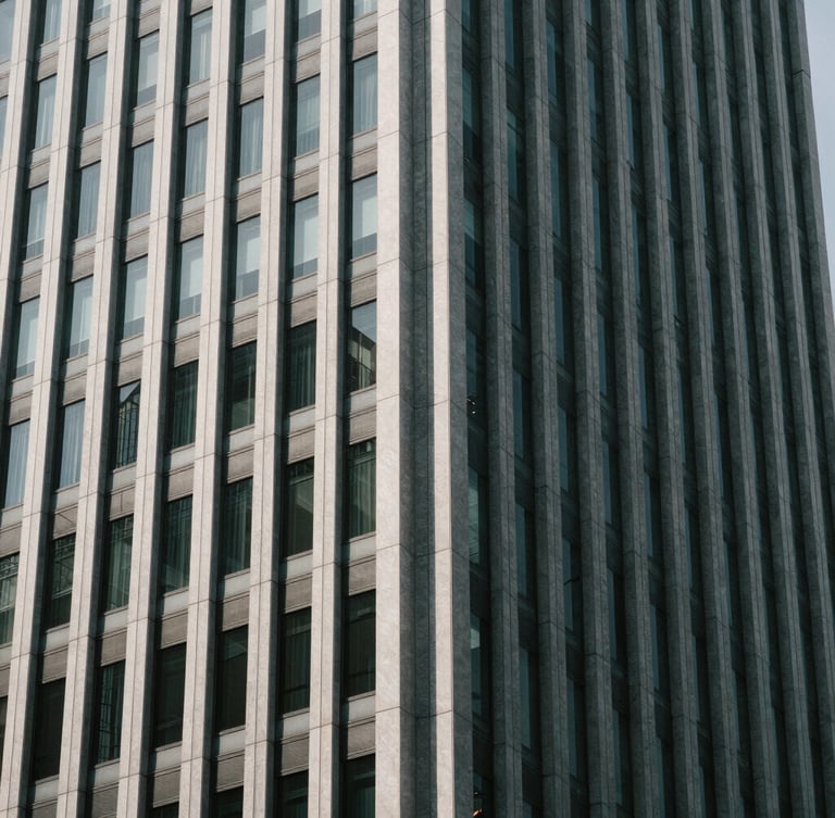 Abstract architectural pattern of a modern corporate skyscraper facade, high-contrast shadows, cool desaturated tones, 35mm