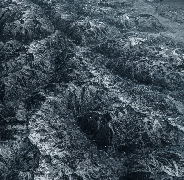 Wide panoramic desaturated high-altitude satellite topography of the Rocky Mountains, showing subtle wireframe overlays and data points, cold high-contrast laboratory light, extreme overhead perspective.