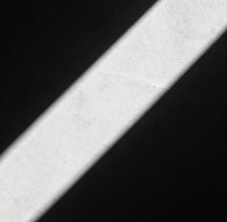Extreme close-up of high-contrast architectural concrete shadows, hard directional studio light, deep black and white tones, 35mm film grain