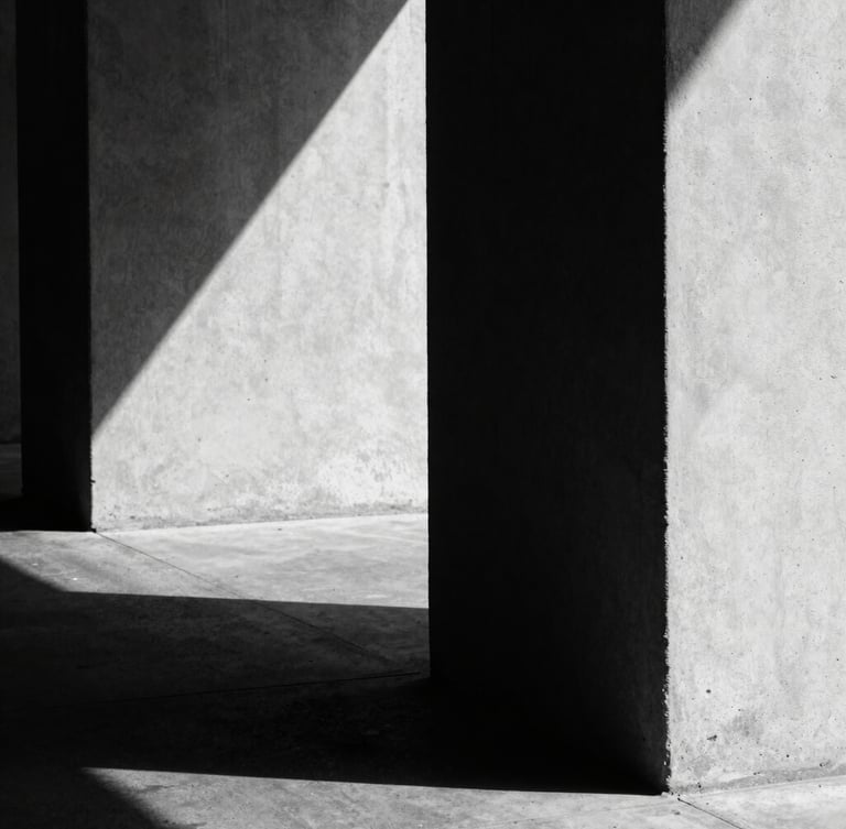 Extreme close-up of high-contrast architectural shadows on raw concrete, hard directional light, deep shadows, desaturated black and white, 35mm film grain