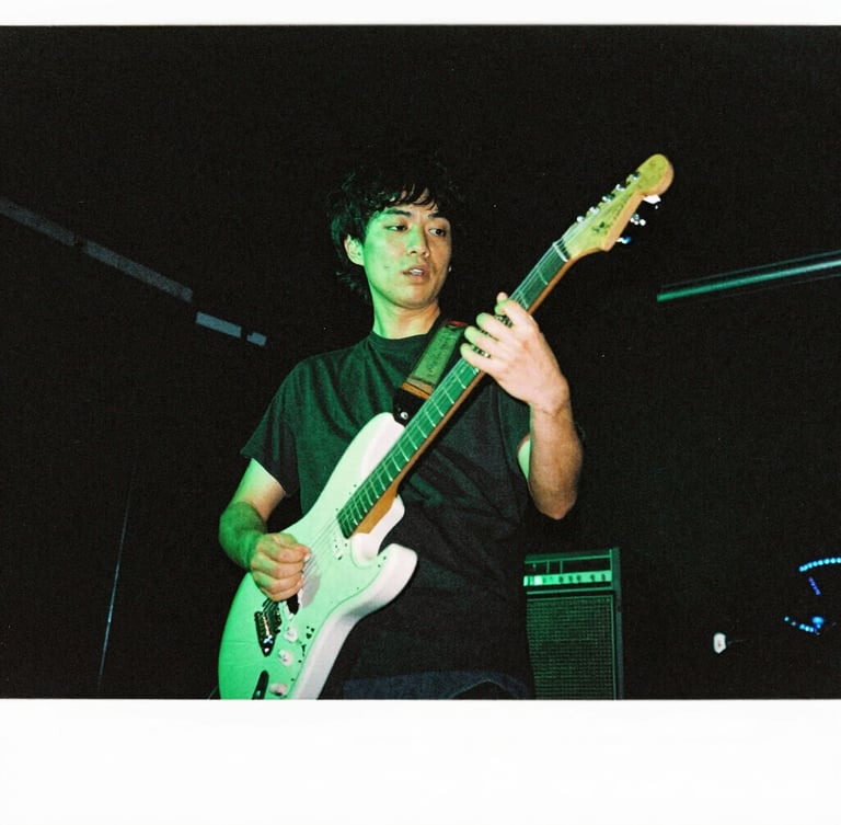 Low-angle gritty concert photography of a guitarist performing under high-contrast neon acid-green stage lighting, dark atmospheric background, 35mm flash style