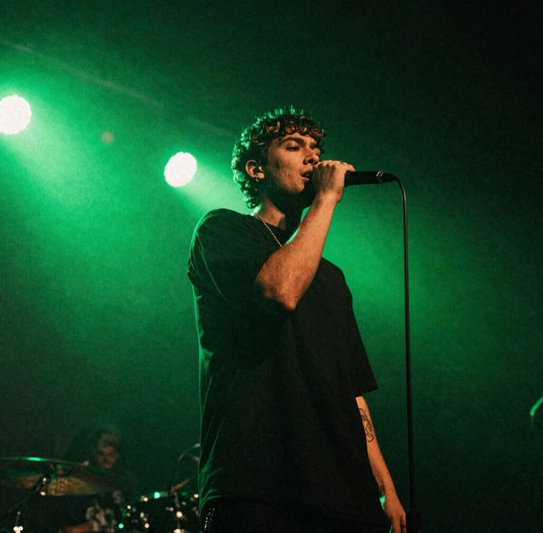 Low-angle gritty concert photography of an independent artist performing on stage under high-contrast neon green backlights, 35mm flash photography style.