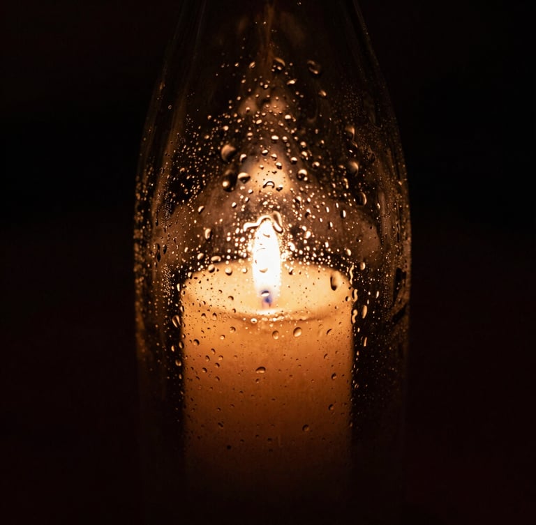 Tight macro shot of condensation on a dark glass bottle of biodynamic wine, warm candle-light reflecting on wet glass, deep shadows, 35mm film grain