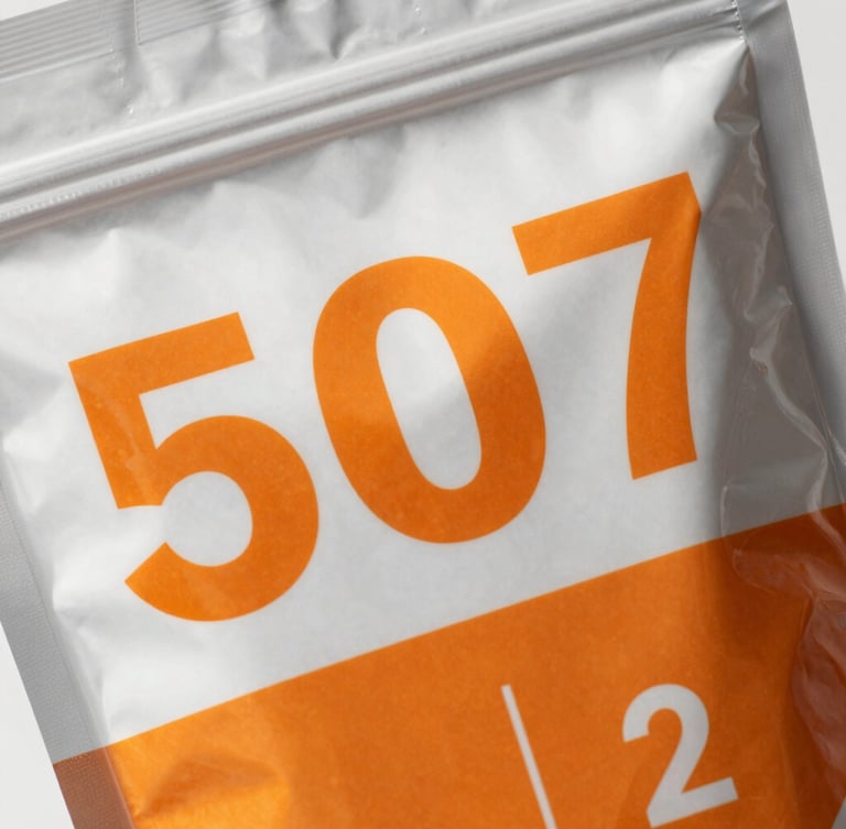 Macro detail shot of a custom-printed mylar bag showing sharp text and vibrant orange graphics, bright clean daylight on metallic foil textures, neutral background, high detail, 50mm