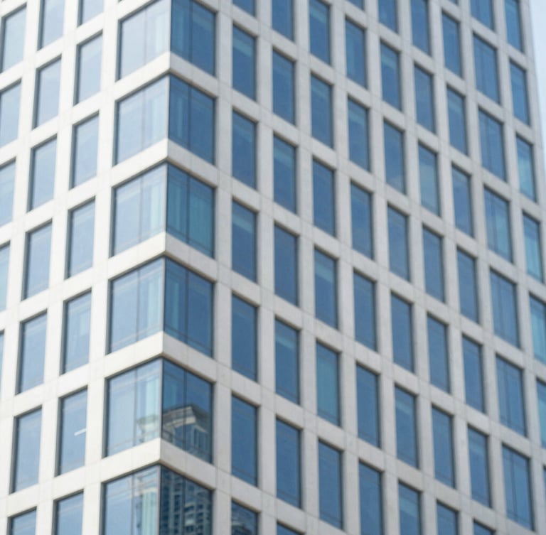 Close-up architectural detail of a modern glass skyscraper in Mumbai reflecting bright daylight, clean lines, minimalist editorial style, 35mm.