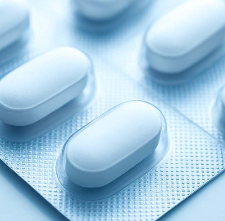 Macro focus on pharmaceutical tablet strips in a sterile blister pack, clinical white light with soft blue highlights, high-compliance manufacturing, 50mm