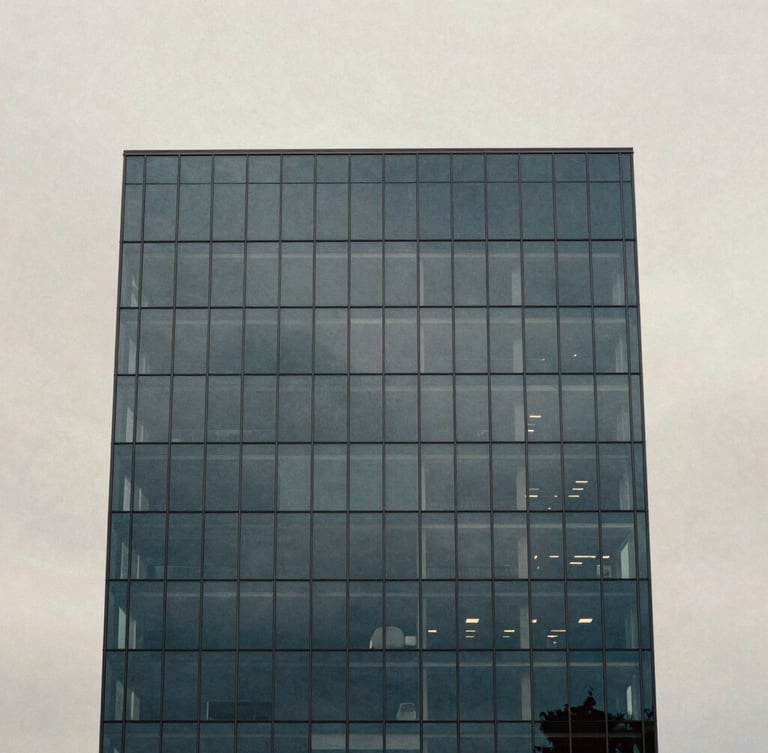 Minimalist architectural photography of a modern coastal glass tower facade reflecting soft overcast daylight, deep slate tones, medium format film