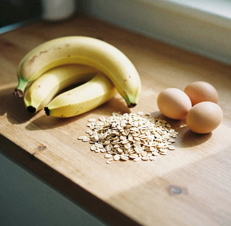 Detail shot of fresh bananas, oats, and organic eggs arranged on a rustic wooden kitchen counter, soft morning sun casting long shadows, warm lifestyle photography, 35mm film look