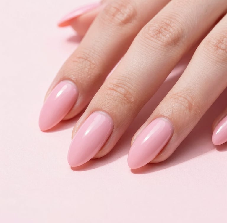 Macro shot of a hand with long, high-gloss pink almond nails resting on a clean blush surface, bright studio lighting