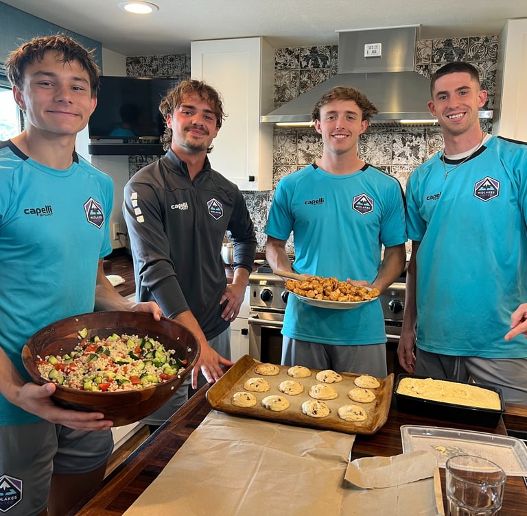 Midlakes soccer players showing off the meal with cookies they have prepared for The Sophia Way.