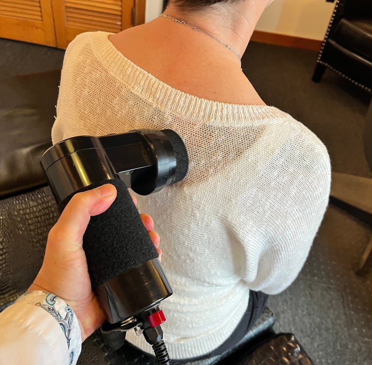 Dr. Lonna Denny utilizing an advanced technology to help relieve patient's back pain.