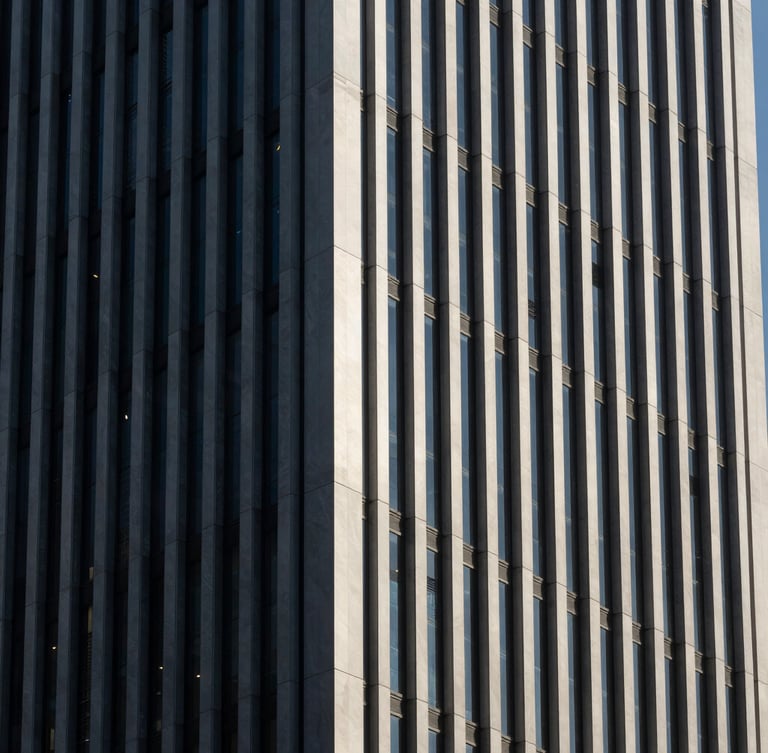 High-contrast architectural detail of modern Istanbul business district skyscraper facade, sharp natural side-lighting, deep obsidian shadows, clean vertical lines, minimal composition