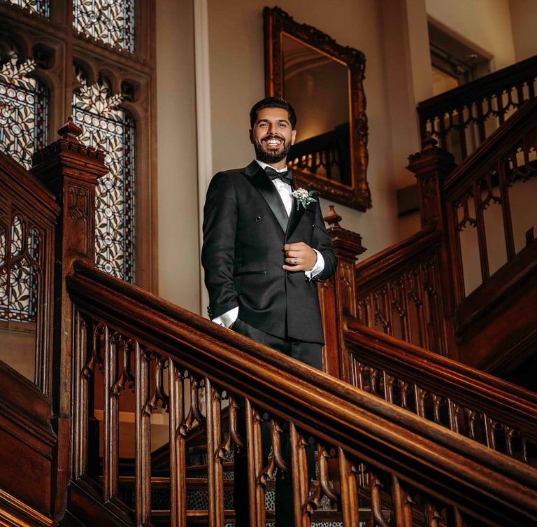 Groom portrait on elegant wooden staircase – classic Oxford wedding photography by Fred Art Studio