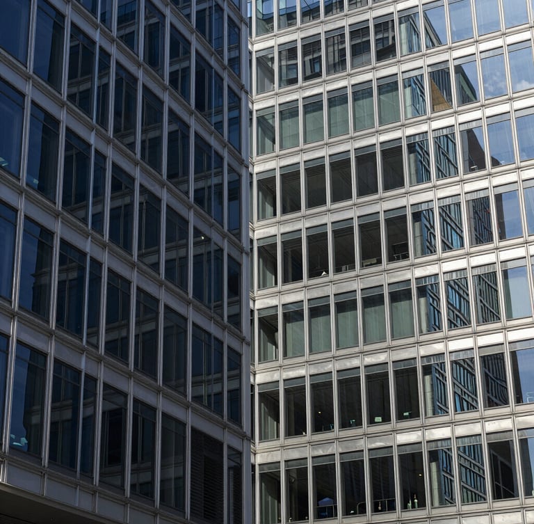 Cool corporate architecture, abstract geometric patterns of glass and steel, crisp daylight with subtle silver reflections, sharp focus, 35mm