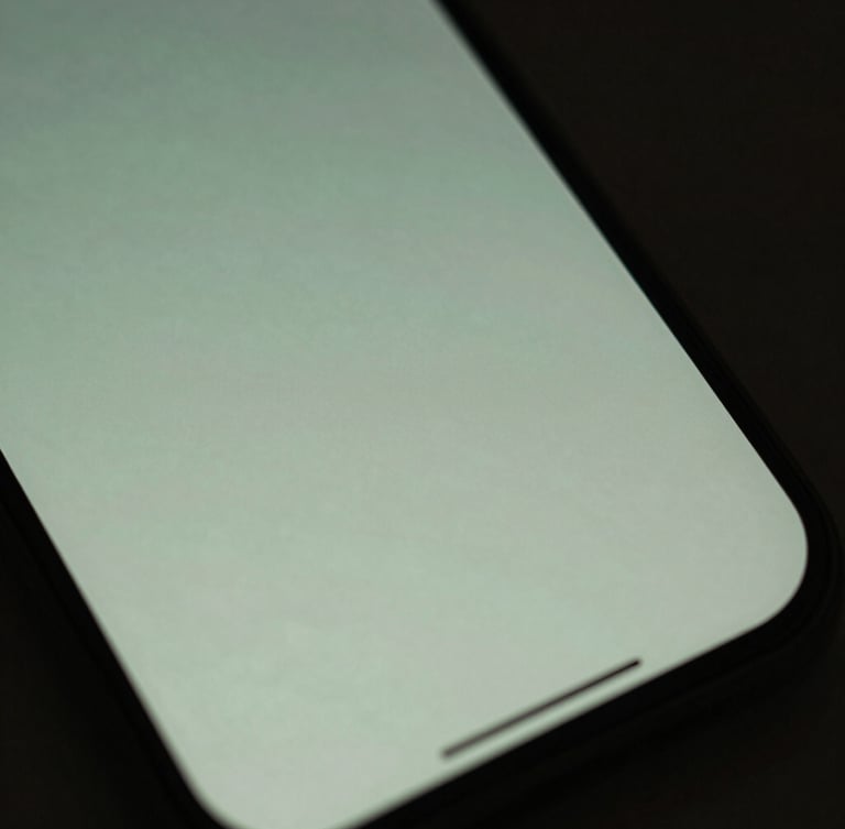 Macro close-up of a smartphone screen displaying a soft, glowing, minimalist interface with muted sage green tones, diffused dusk lighting