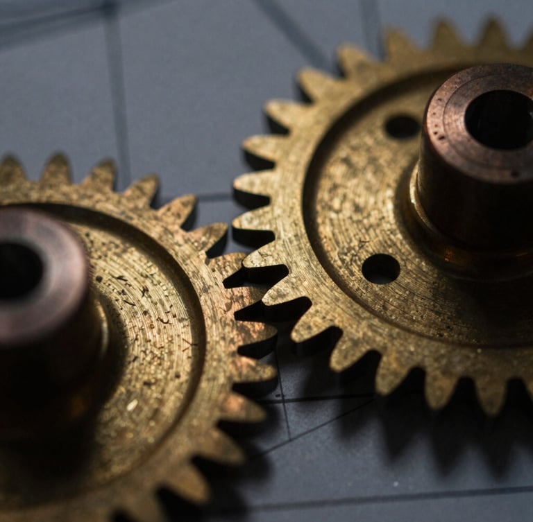 Macro detail of burnished brass mechanical gears, low-key chiaroscuro lighting with warm metallic reflections, technical blueprint lines faintly visible in the background, 35mm