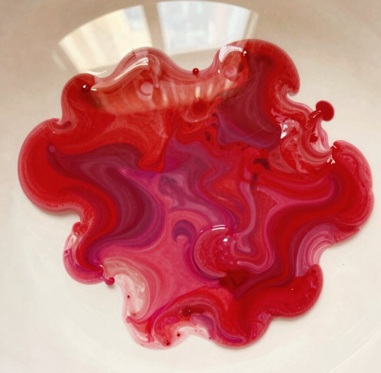 Abstract macro shot of vibrant red and magenta paint blending in water, high contrast, warm editorial photography, 35mm