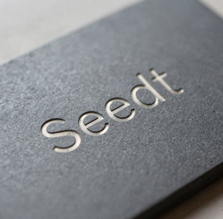 Macro shot of a steel seed phrase backup plate with engraved words, natural light, muted slate and metallic tones, sharp focus.