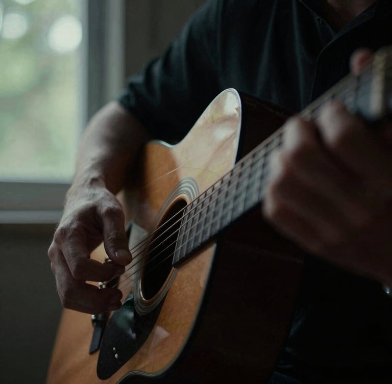 Extreme close-up of hands on acoustic guitar strings, moody natural window light, deep shadows, desaturated forest tones, 35mm film grain