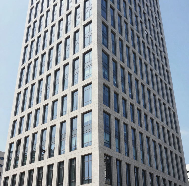 Crisp commercial photography of a modern high-rise office building exterior in daylight, clean architectural lines, wide angle 35mm