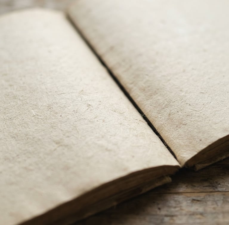 soft natural light photography, close-up of the textured paper of an open book, minimalist composition, muted neutral tones, shallow depth of field, 50mm