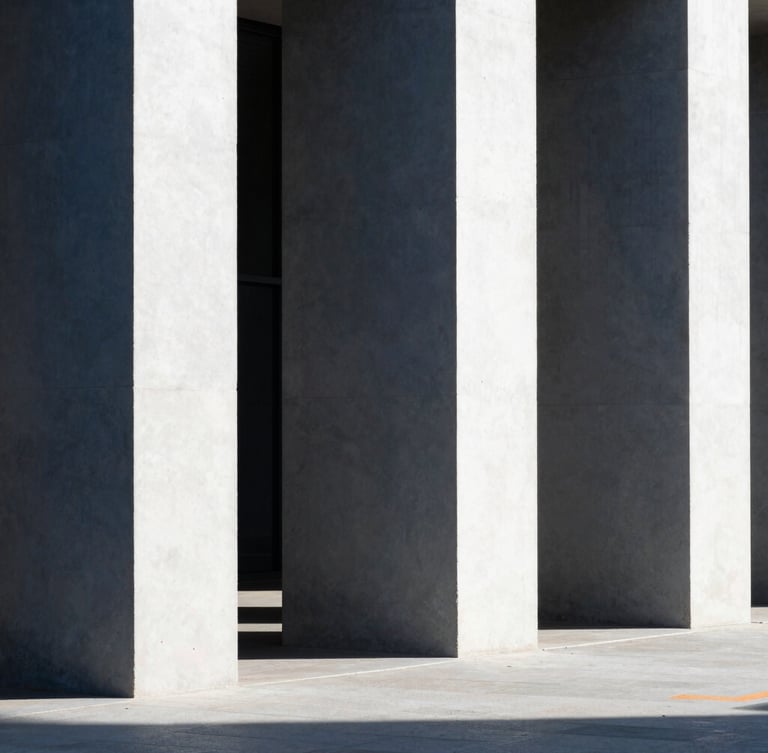 Minimalist architectural photography, clean concrete pillars casting long rhythmic shadows in bright daylight, sharp contrast, navy tones, 35mm lens