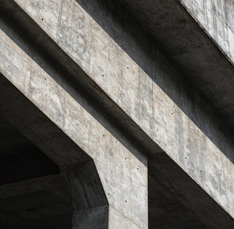 Extreme close-up of brutalist concrete structure, sharp geometric shadows, cool natural light, architectural detail.