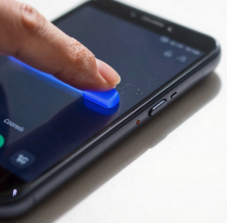 Extreme close-up macro shot of a thumb sliding a bright blue volume slider on an Android phone, casting a sharp shadow onto a white desk.