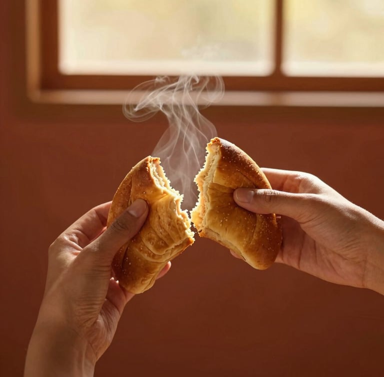 A portrait-oriented, warm editorial photograph of a golden-brown sheca being gently torn in half by hand, steam rising from the soft interior, rich terracotta background, shallow depth of field, 35mm