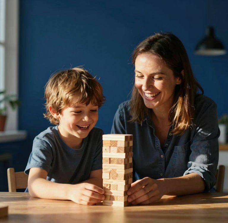 A warm, candid photo of a mother and her young son sitting together at a wooden table, laughing while building a wooden block tower, golden hour sunlight streaming through the window