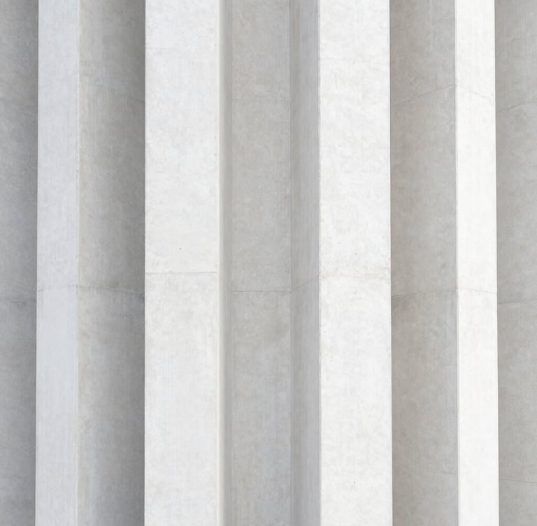 Symmetrical close-up of structural concrete columns under diffused daylight, sharp architectural lines, premium texture