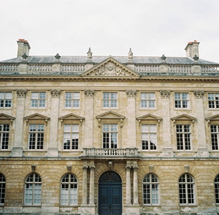 Symmetrical architectural view of a historic European university facade in soft overcast daylight, muted scholarly tones, 35mm film look