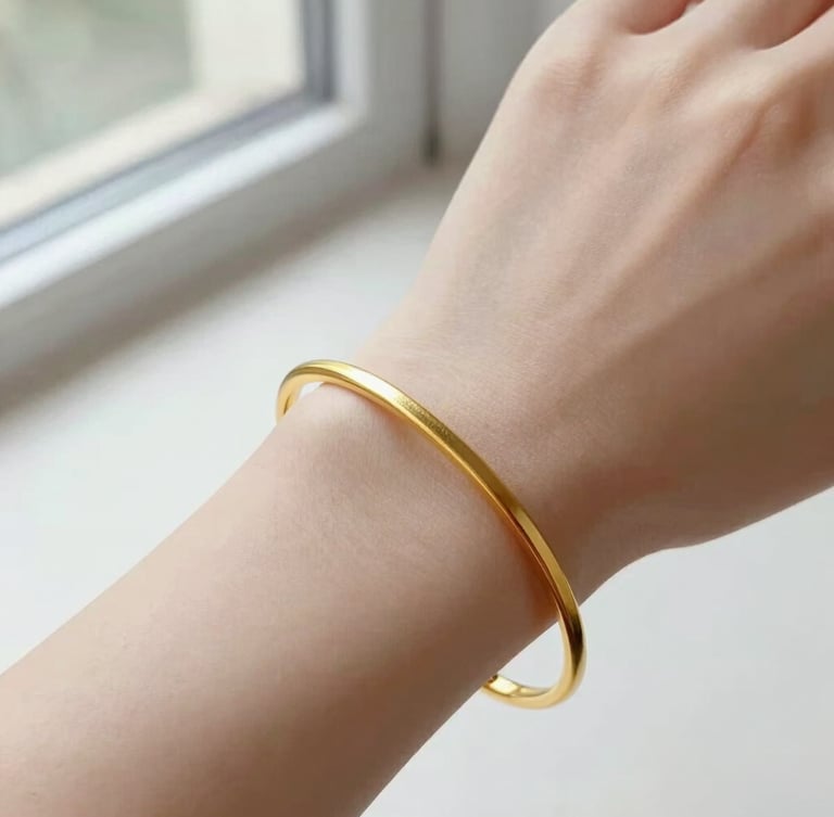 Elegant close-up of a continuous gold bracelet on a wrist, soft natural window light, bright high-key editorial aesthetic