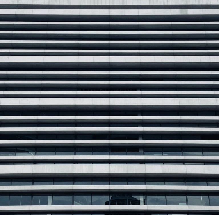 Close-up of structured legal documents and architectural lines of a modern civic building, cool diffused daylight, desaturated navy tones.
