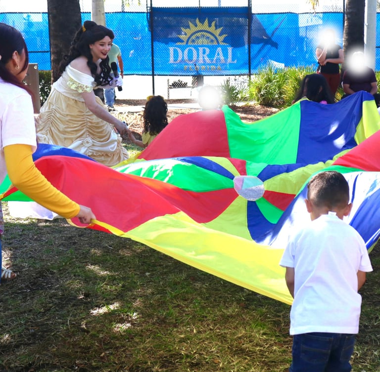 A group of kids playing parachute fun with princess Dell as the entertainer