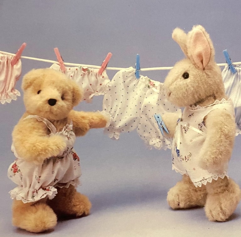 a plush Muffy bear and Hoppy hare hanging underthings out on a wash line