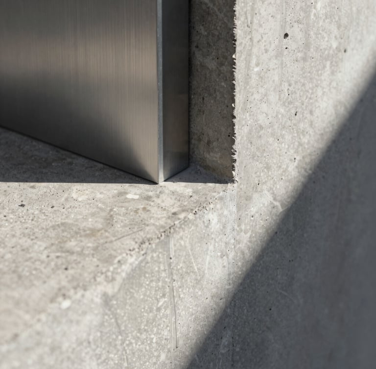Extreme close-up of raw concrete meeting brushed steel in a minimalist architectural joint, sharp shadows, high-contrast natural light
