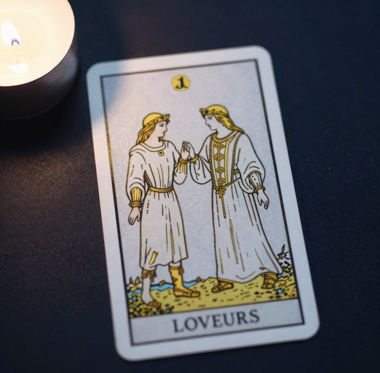Top-down view of a single tarot card depicting the Lovers, modern minimalist gold line art, placed on a dark surface under dramatic moonlight