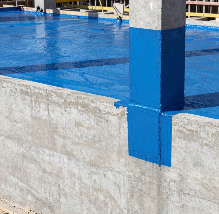 Industrial construction site in India, close-up of heavy-duty blue polyurethane waterproofing coating being applied to a thick concrete foundation wall, bright daylight, professional architectural photography
