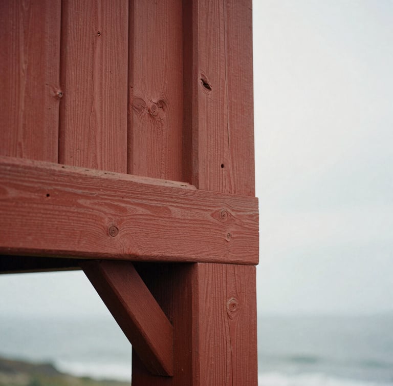 Close-up detail of weathered, hand-hewn redwood timbers with historic mortise-and-tenon joinery, soft natural side lighting, tactile wood grain, warm archival tone.