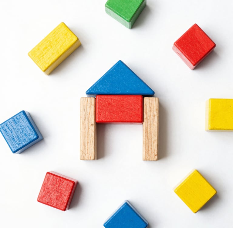 Overhead flatlay of premium unbranded wooden toy blocks and minimalist geometric shapes, bright high-key product photography, seamless white backdrop, crisp studio light, vibrant primary accents, sharp focus