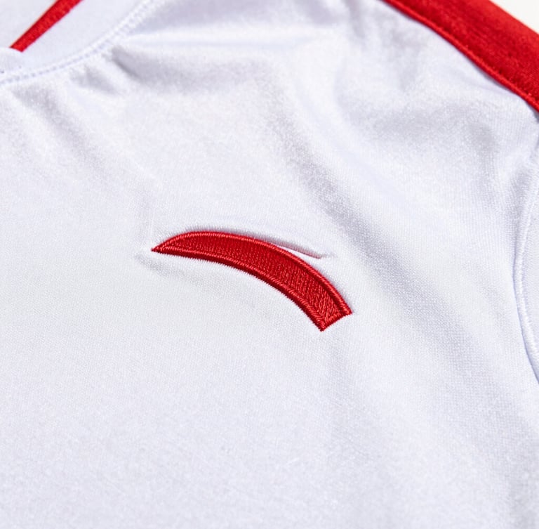 Close-up of highly textured athletic fabric with clean custom embroidery, bright natural lighting, sharp focus on stitching