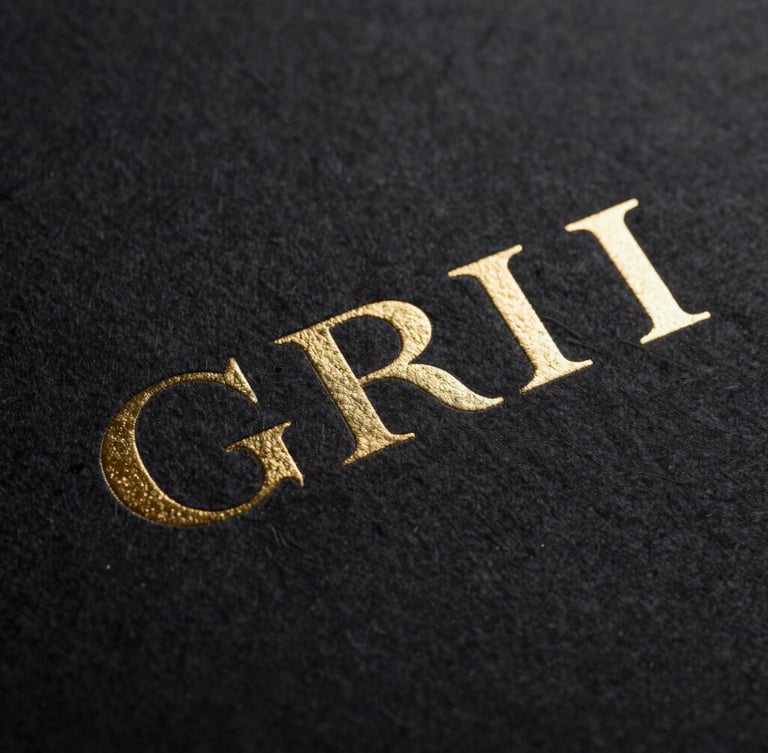 Macro photograph of embossed gold foil lettering on thick black cotton paper, sharp focus, dramatic low-key studio lighting, luxury corporate branding