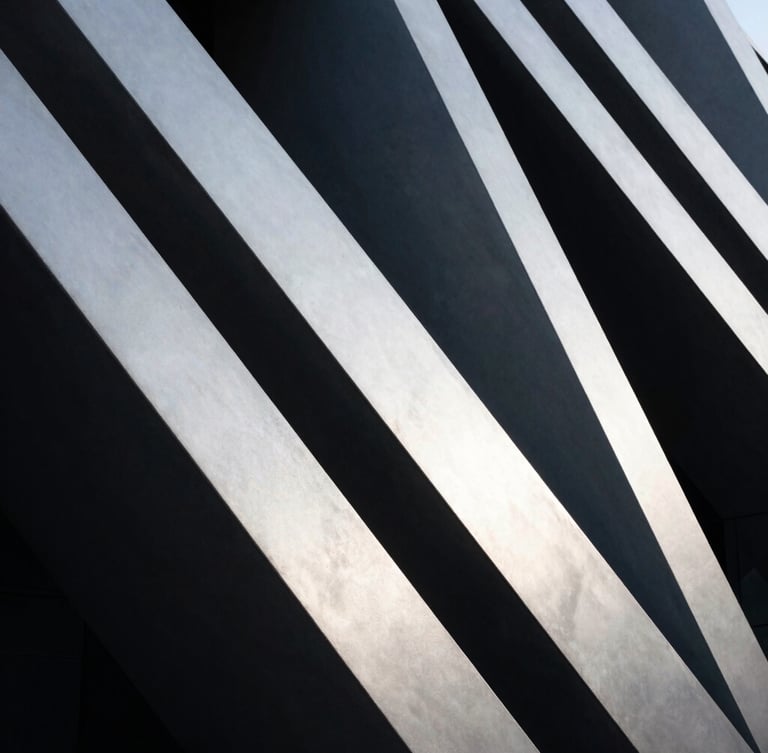 Abstract high-contrast architectural geometry with strong leading diagonal lines, cool silver tones, deep slate shadows.