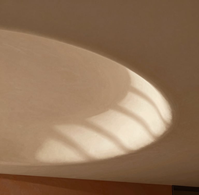Close-up of a contemporary architectural detail, elegant curved plaster ceiling, soft natural daylight casting subtle geometric shadows, warm sand tones, minimalist aesthetic