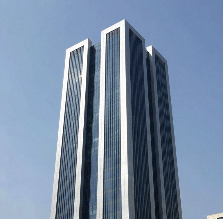 Crisp architectural photography of a modern commercial tower in Doha under bright natural daylight, clean navy and silver tones, sharp focus, professional technical aesthetic.